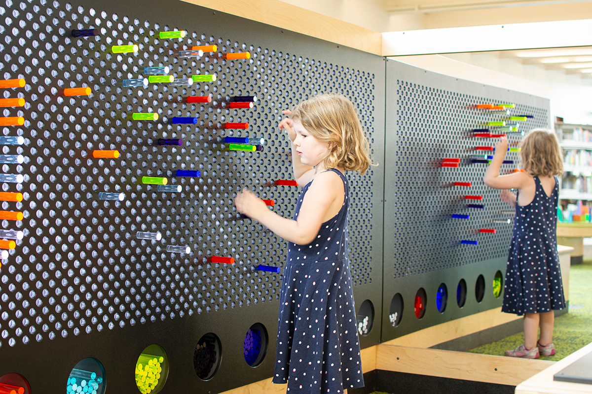 girl playing with a light bright
